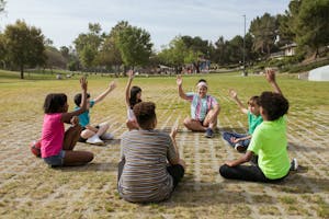 A group of kids having fun playing games together in a sunny park setting.